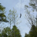person on high elevation zip line
