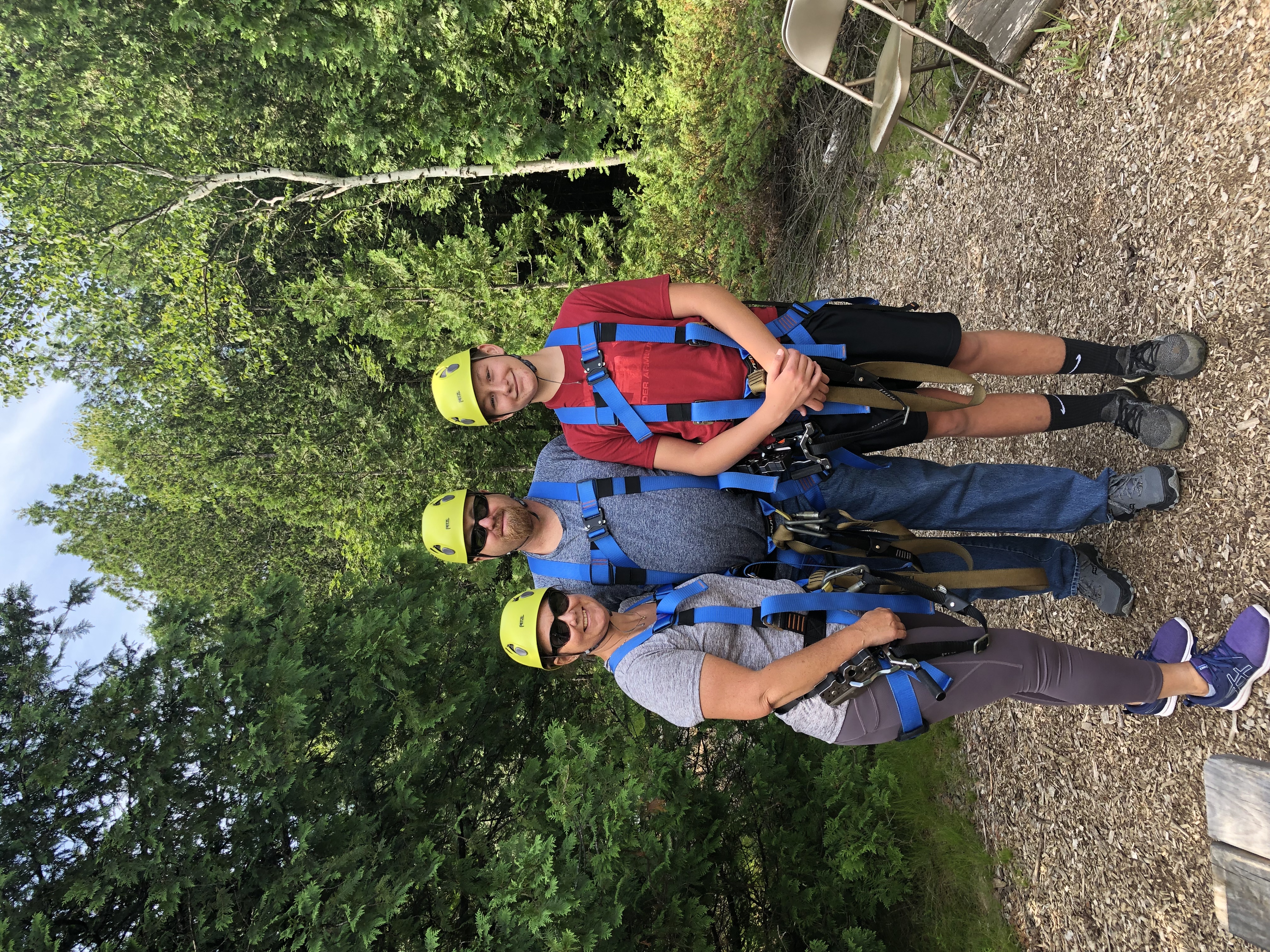 group wearing zipline gear in wisconsin forest